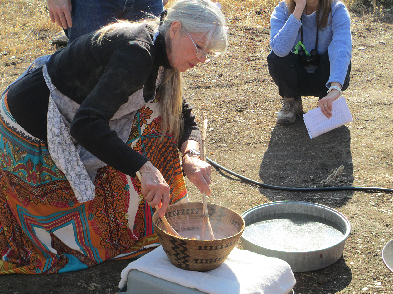 Lois Conner Bohna preparing acorn in traditional basket